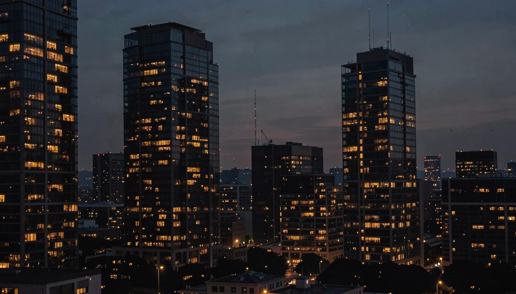 Dark atmospheric city skyline at dusk with warm amber lights reflecting off glass towers, moody and luxurious