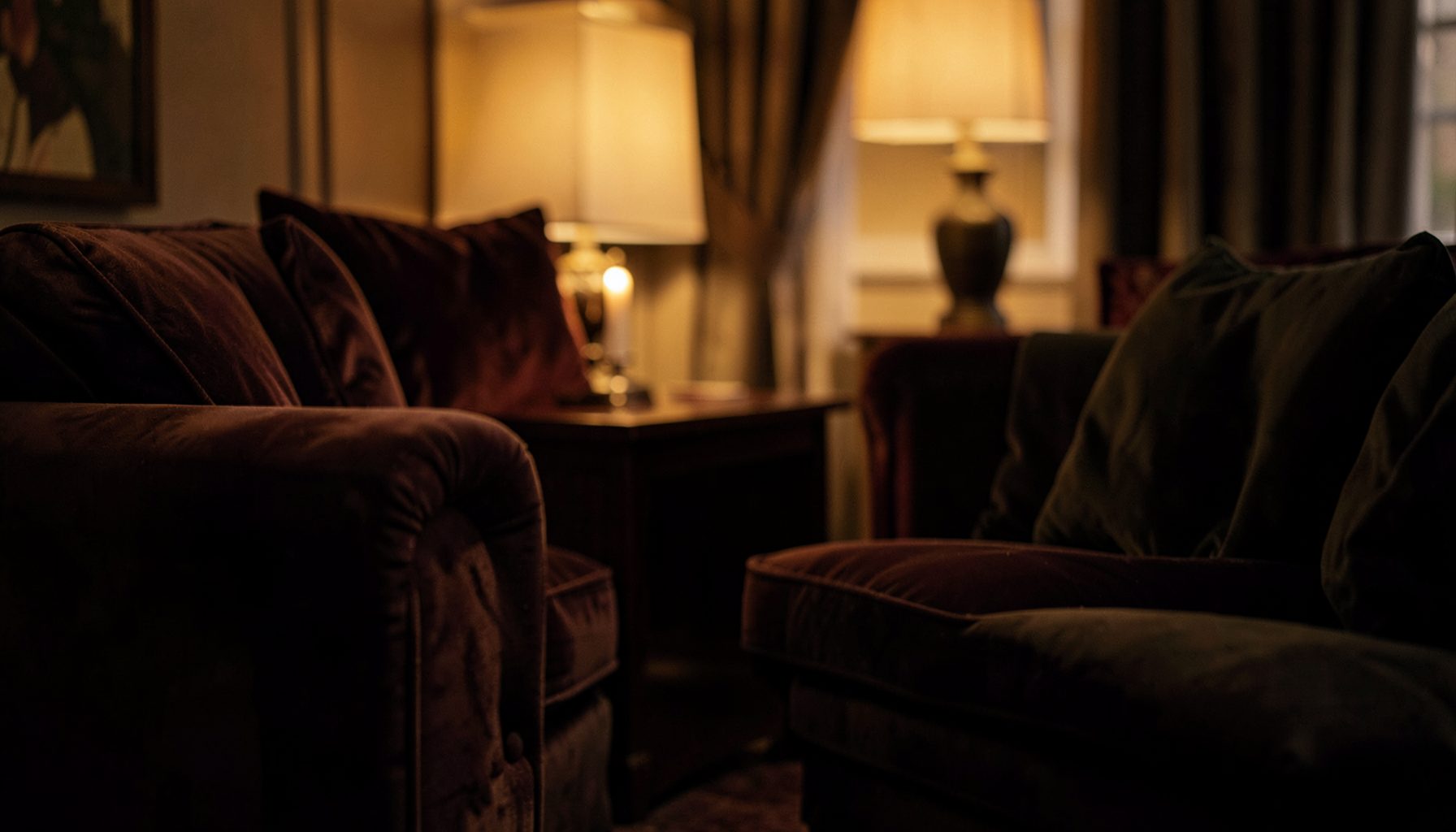 Warm interior scene with soft amber lighting and velvet textures, intimate and refined